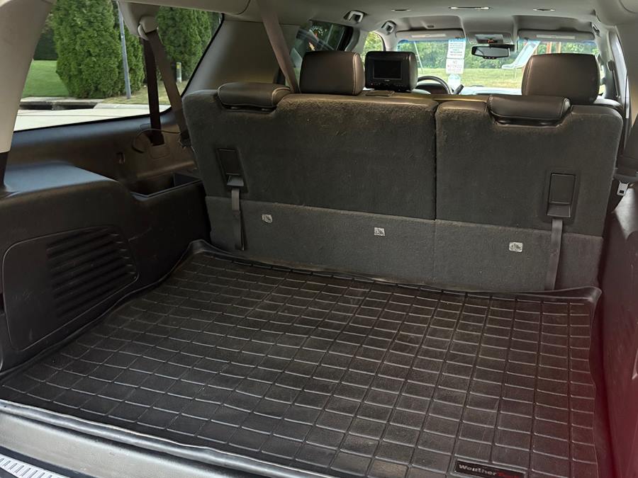 The same SUV cargo area after detailing, with clean seatbacks and floor mat