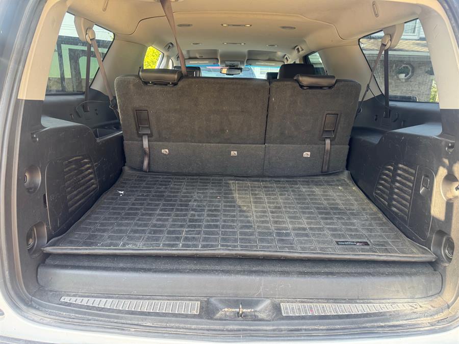 SUV cargo area before detailing, with pet hair on the seatbacks and a dirty floor mat