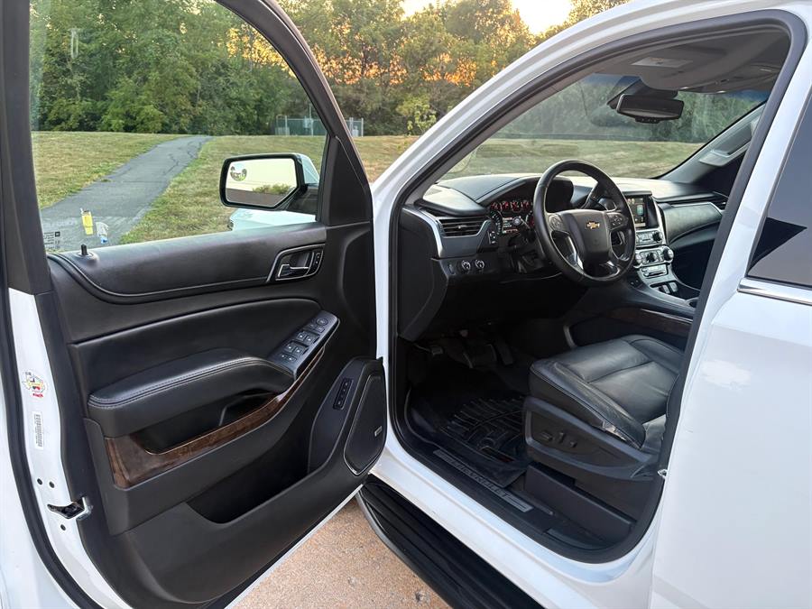 Driver's side after detailing, with a clean floor mat, sill and door panel
