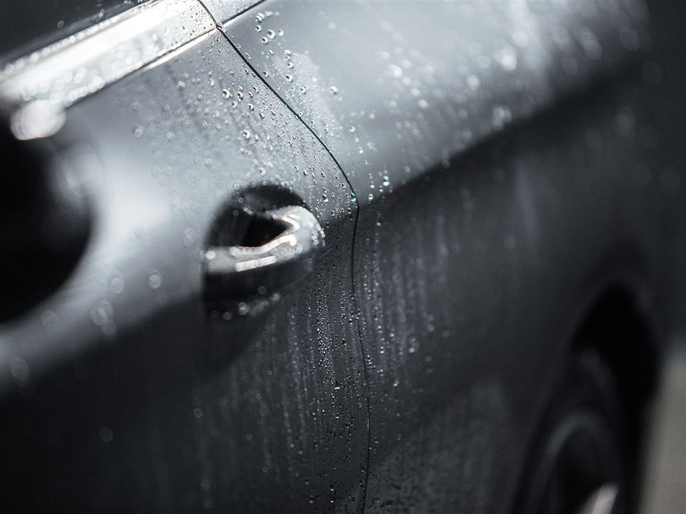 Stock photo: water beading on clean black paint
