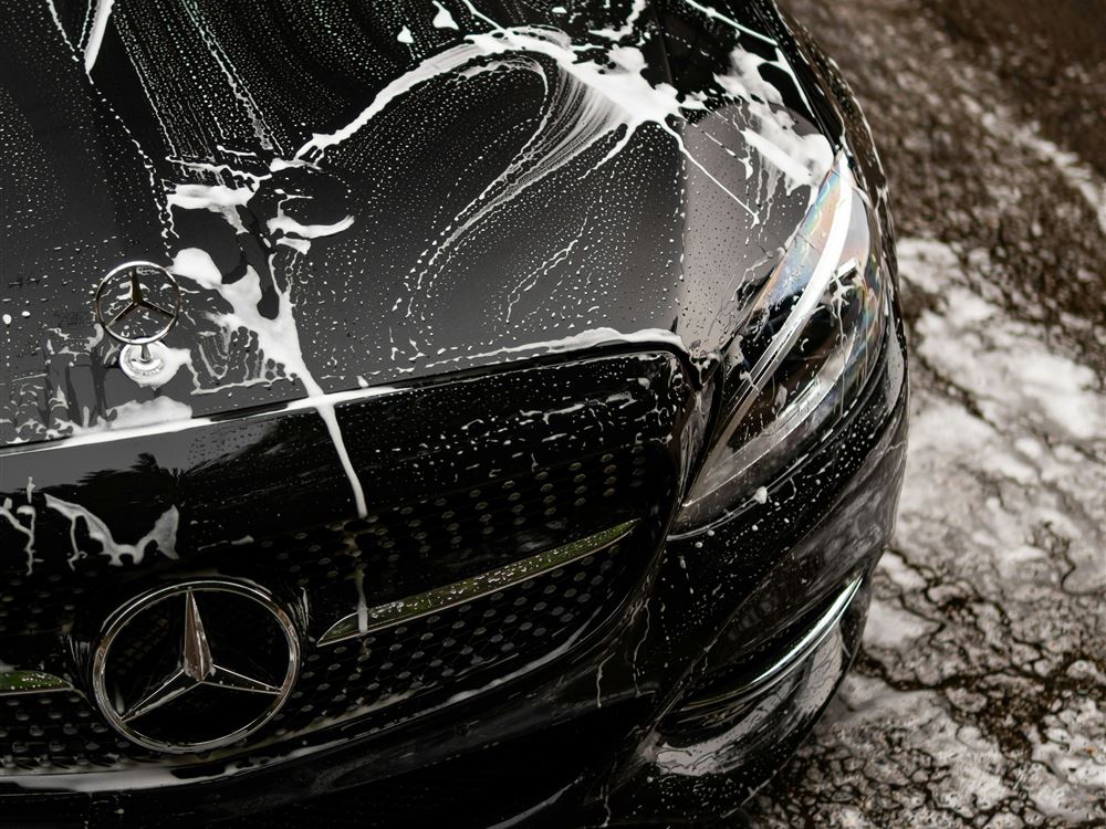 Stock photo: black car covered in wash foam